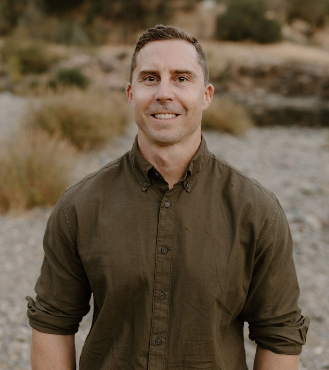 Dan Johnson outdoors in an olive collared shirt